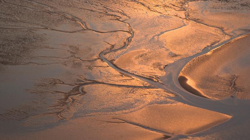 Aerial image of tidal flat in sunset colours. © CWSS/ Martin. Stock. Aerial image of tidal flat in sunset colours. © CWSS/ Martin. Stock.