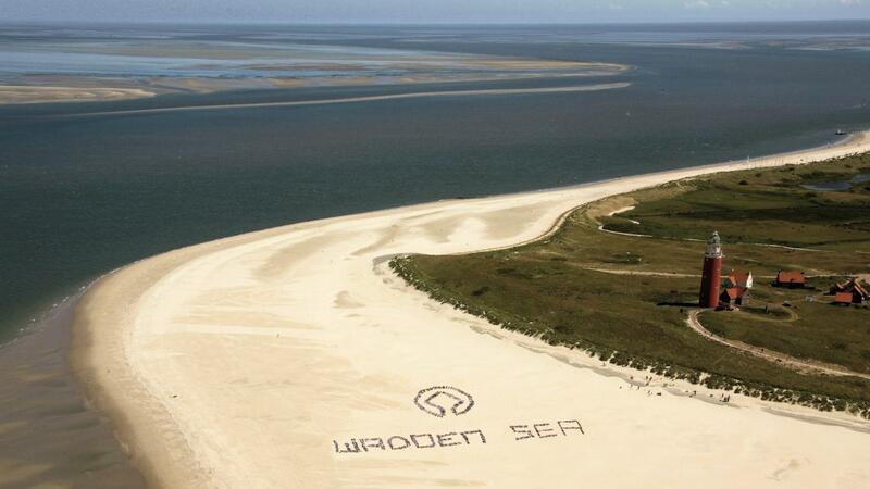 World Heritage emblem on beach. Pieter de Vries.
